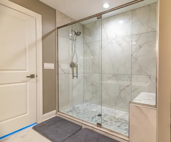 a bathroom with a glass shower door