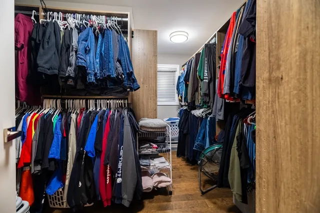 a view of walk in closet with clothes