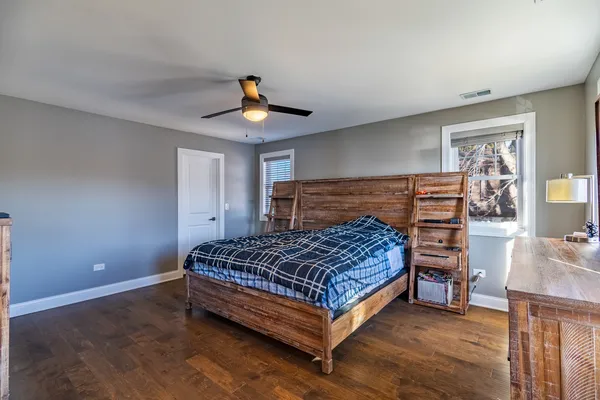 a bedroom with a bed and a chandelier
