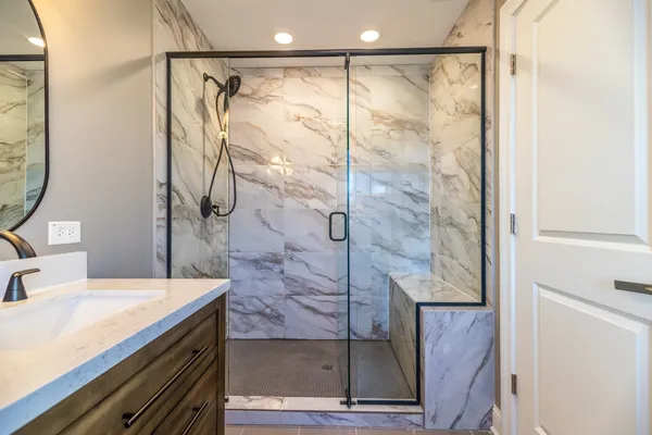 a bathroom with a shower and a sink