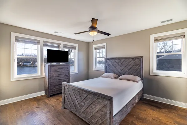 a bedroom with a bed and a flat screen tv