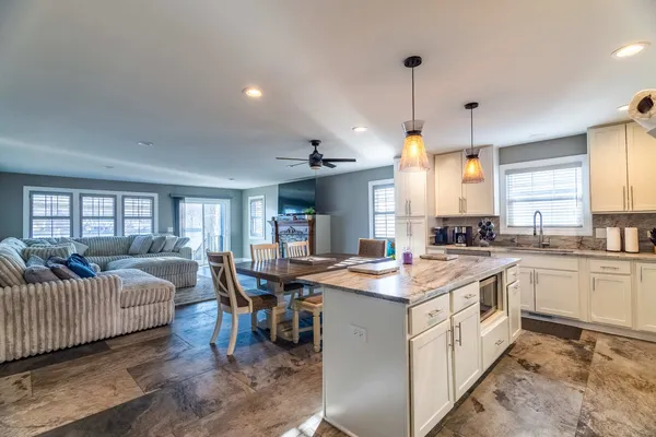 a open kitchen with stainless steel appliances granite countertop a sink stove and refrigerator