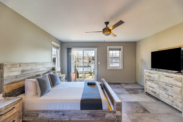 a bedroom with a bed and flat screen tv