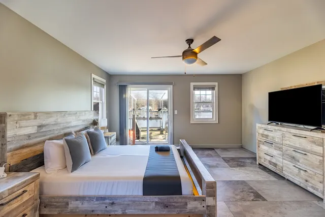 a bedroom with a bed and flat screen tv