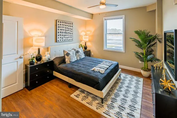 a bedroom with a bed and a potted plant