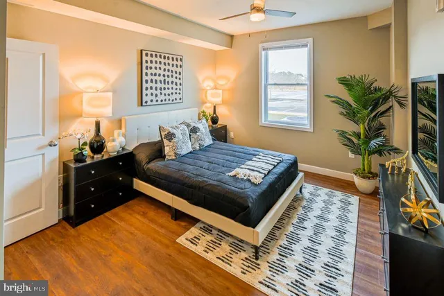 a bedroom with a bed and a potted plant