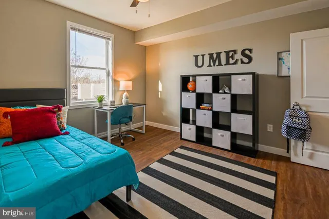 a bedroom with a bed and wooden floor