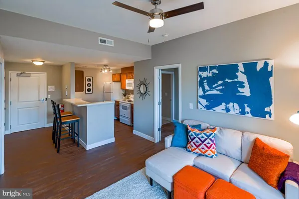 a living room with furniture and wooden floor