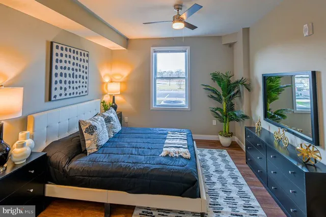 a bedroom with a large bed and a potted plant