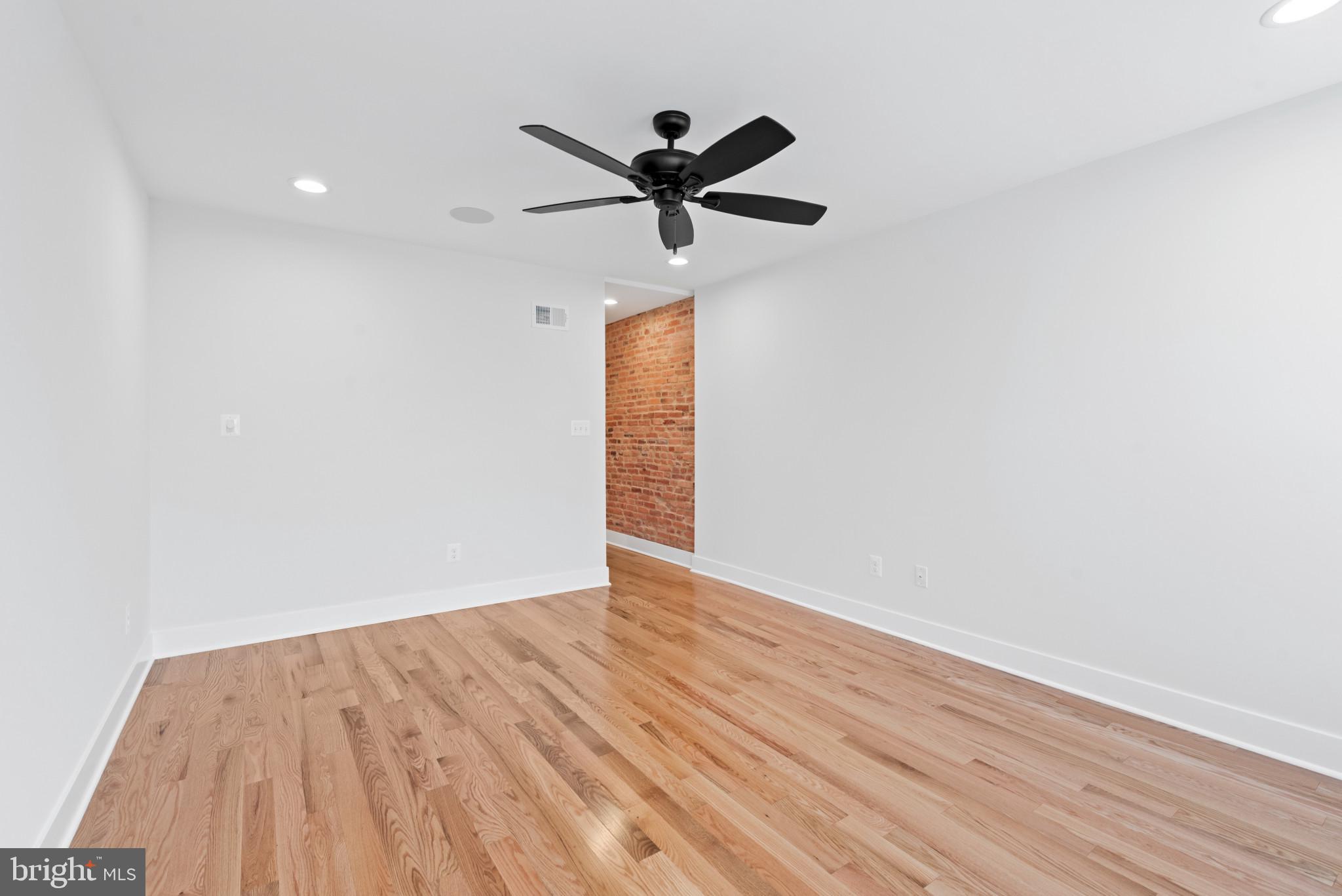 1434 Marshall Street Baltimore, MD 21230 - Photo 20 of 40 a view of empty room with wooden floor and ceiling fan