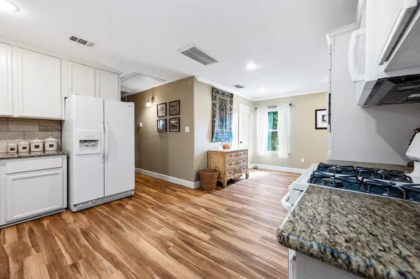 a kitchen with stainless steel appliances granite countertop a stove and a refrigerator