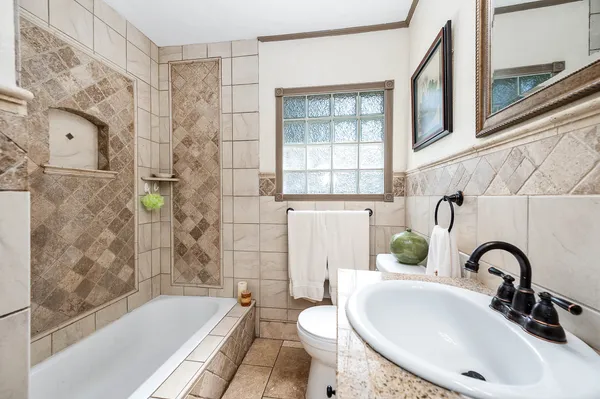 a bathroom with a sink toilet and shower