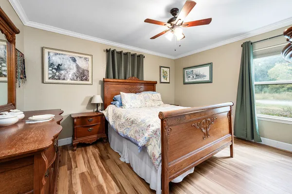 a bedroom with a bed and a chandelier