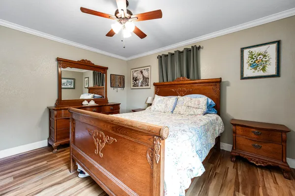 a bedroom with a bed and wooden floor