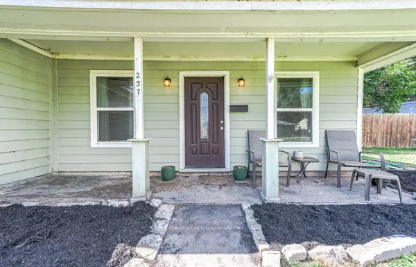 a view of a house with backyard and sitting area