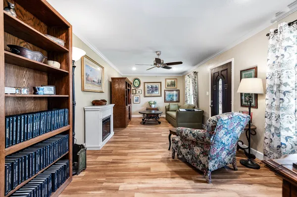 a living room with furniture fireplace and book shelf