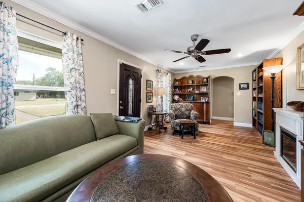 a living room with furniture large window and a flat screen tv