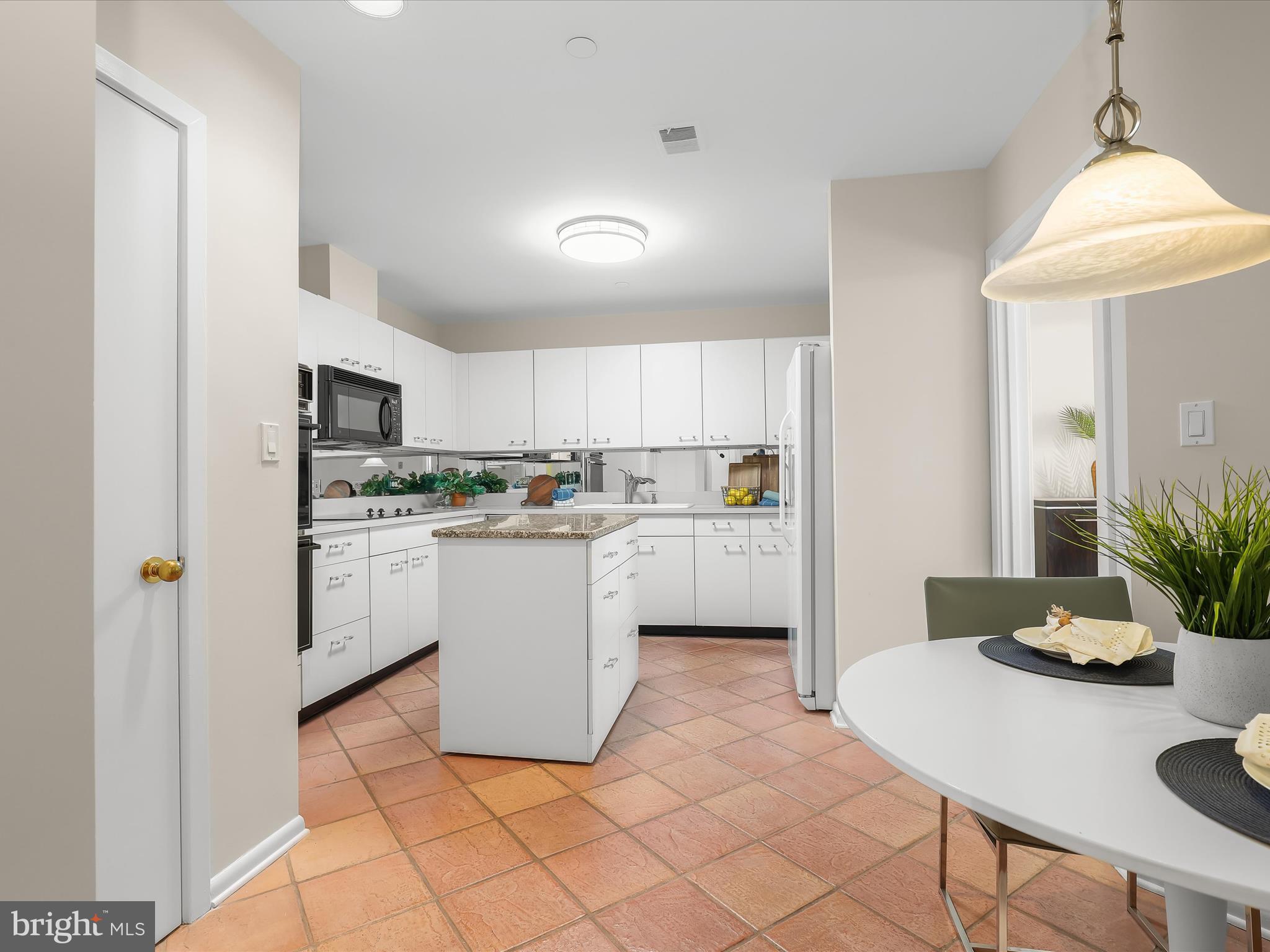 4001 Old Court Road, Unit 519 Pikesville, MD 21208 - Photo 14 of 43 a kitchen with white cabinets and white appliances