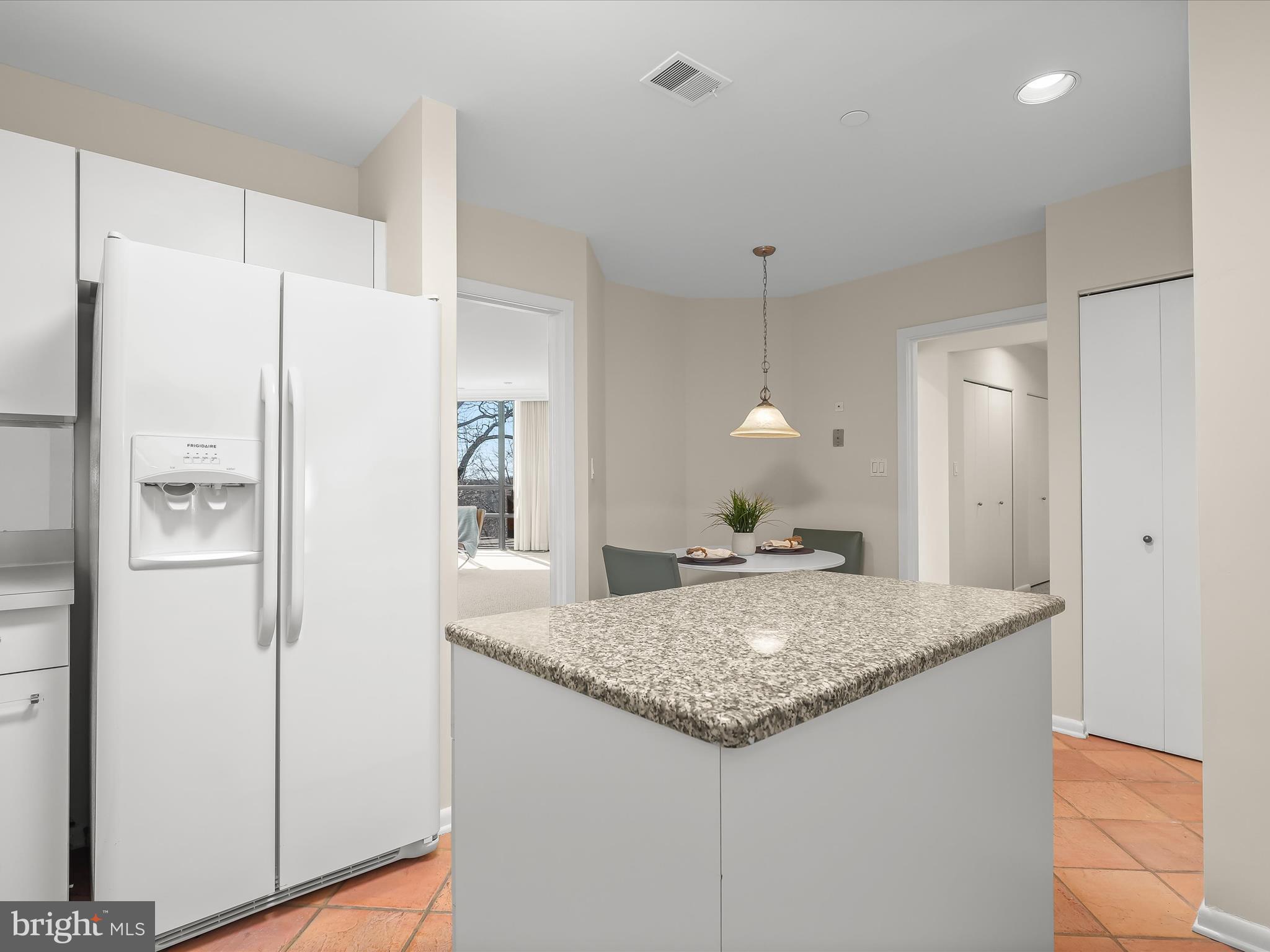 4001 Old Court Road, Unit 519 Pikesville, MD 21208 - Photo 17 of 43 a bathroom with a granite countertop sink and a refrigerator