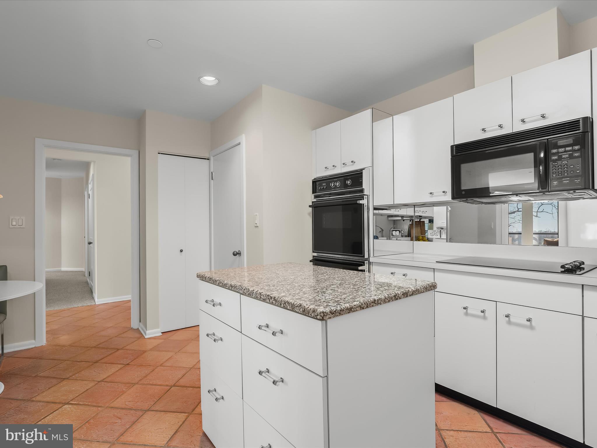 4001 Old Court Road, Unit 519 Pikesville, MD 21208 - Photo 18 of 43 a kitchen with granite countertop white cabinets and stainless steel appliances