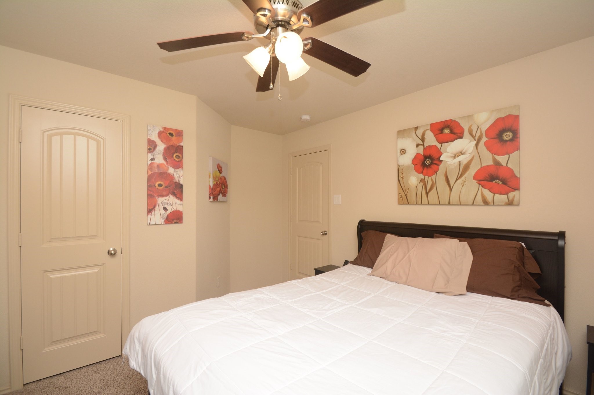 23318 Dukes Run Drive Spring, TX 77373 - Photo 19 of 41 Cozy bedroom featuring neutral walls, a ceiling fan, and a bed. The room is accented with a soft carpeted floor, creating a warm and inviting atmosphere.