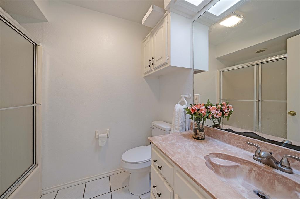 241 High Rdg Drive New Hope, TX 75071 - Photo 14 of 20 a bathroom with a sink toilet vanity and shower