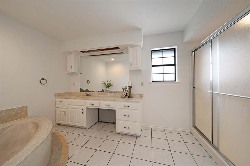 241 High Rdg Drive New Hope, TX 75071 - Photo 16 of 20 a spacious bathroom with a granite countertop sink a mirror and a bathtub