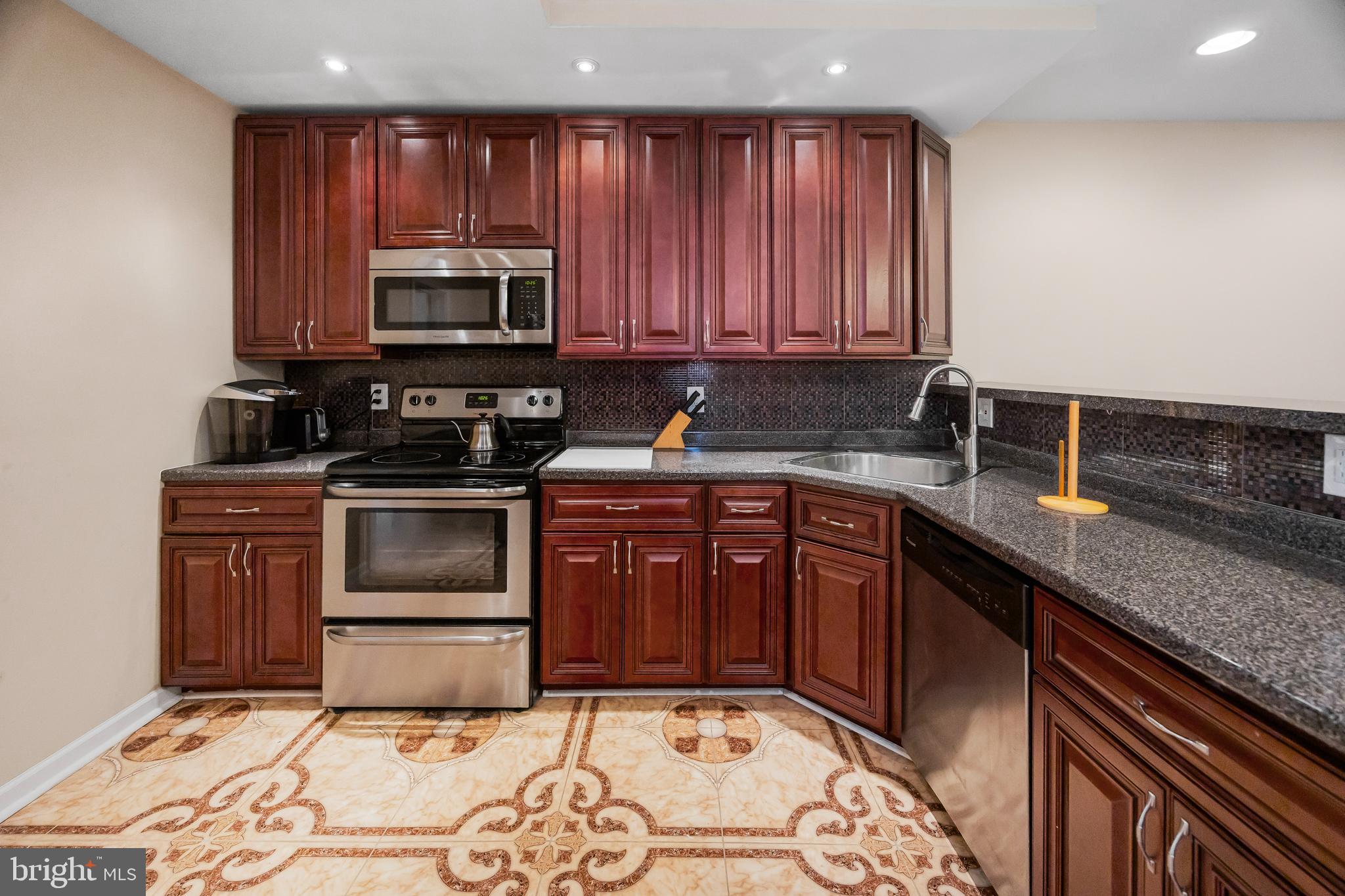 1837 73rd Avenue Philadelphia, PA 19126 - Photo 6 of 19 a kitchen with a sink stove and microwave