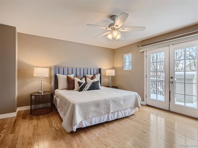 a bedroom with a large bed and a chandelier