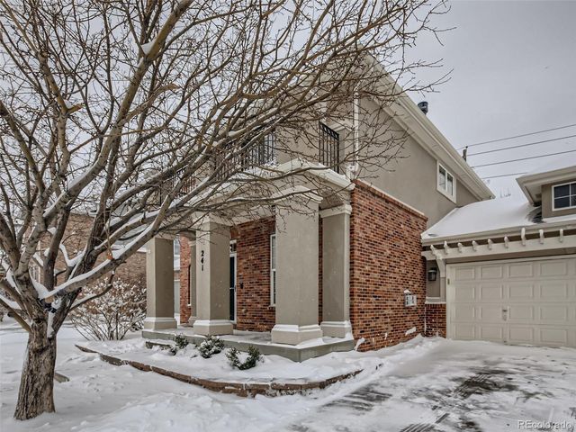 a view of a house with large trees and a tree