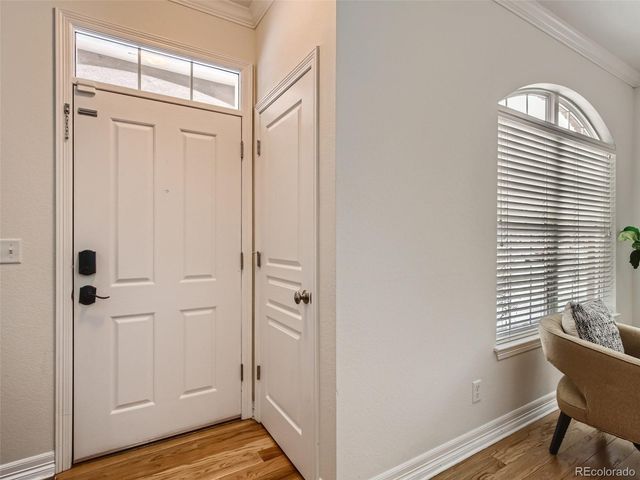 a view of a room with wooden floor and windows