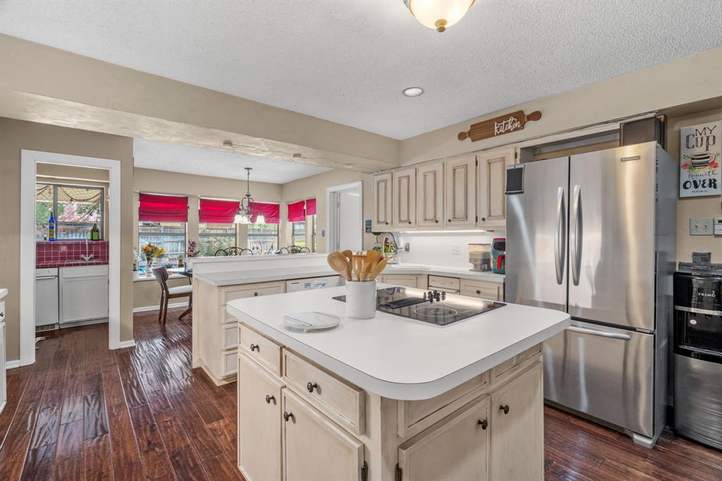 5107 Racquet Club Drive Arlington, TX 76017 - Photo 14 of 40 a kitchen that has a lot of white cabinets and wooden floor
