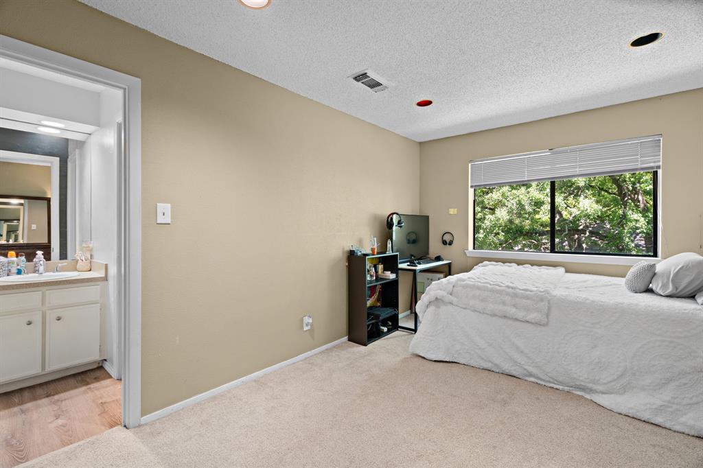 5107 Racquet Club Drive Arlington, TX 76017 - Photo 22 of 40 a bedroom with a bed and a large window