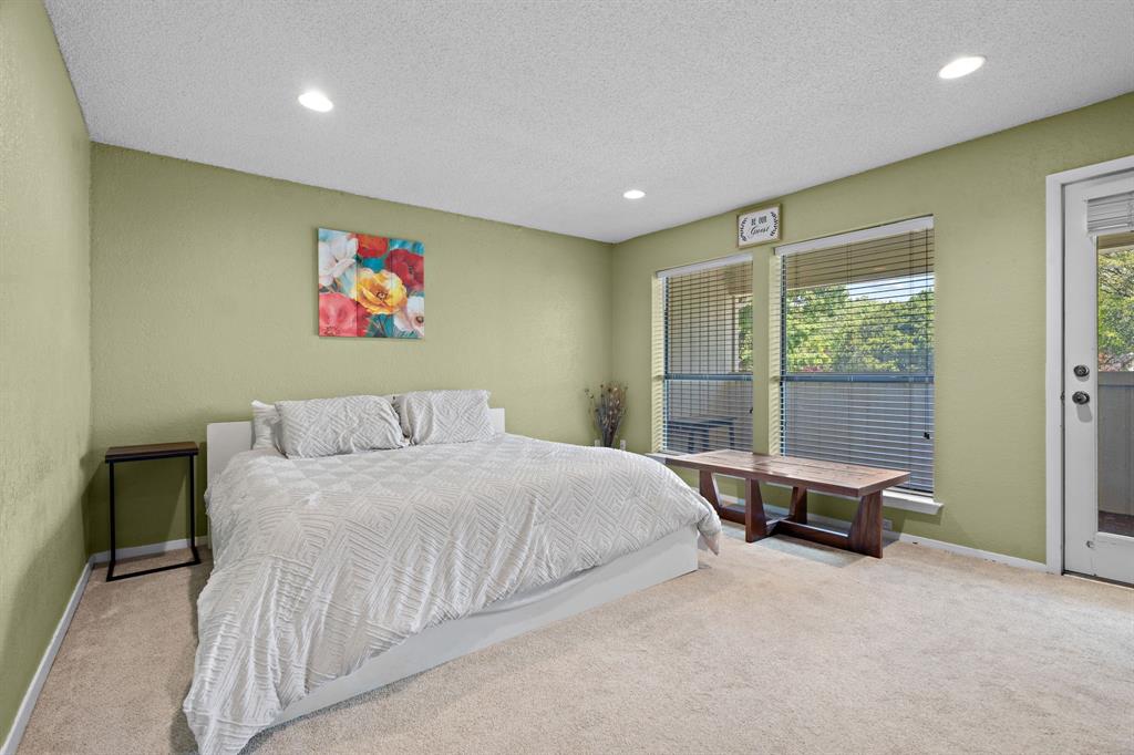 5107 Racquet Club Drive Arlington, TX 76017 - Photo 24 of 40 a bedroom with a bed and glass wall