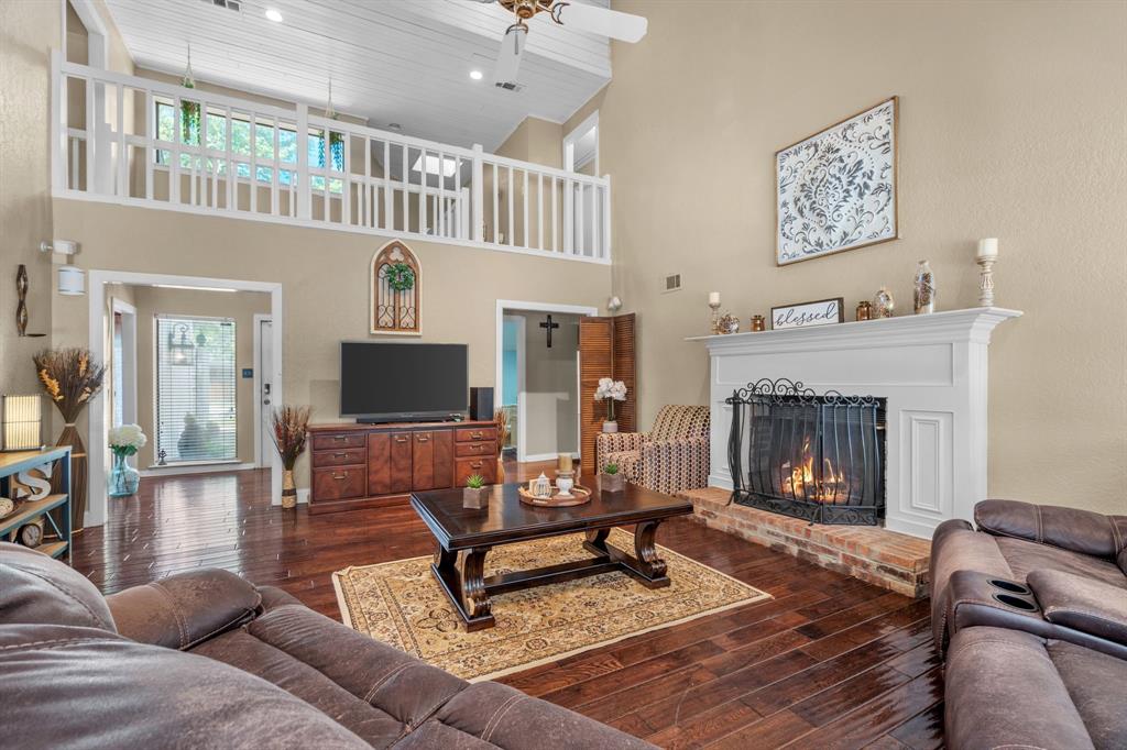 5107 Racquet Club Drive Arlington, TX 76017 - Photo 10 of 40 a living room with furniture and a fireplace