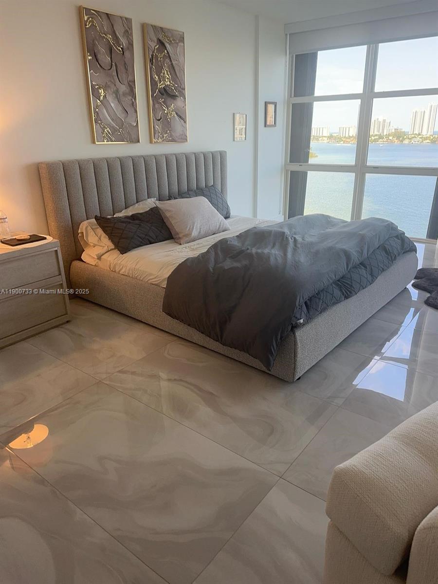 3000 Island Boulevard, Unit 1106 Aventura, FL 33160 - Photo 31 of 71 a bed sitting in a bedroom next to a window