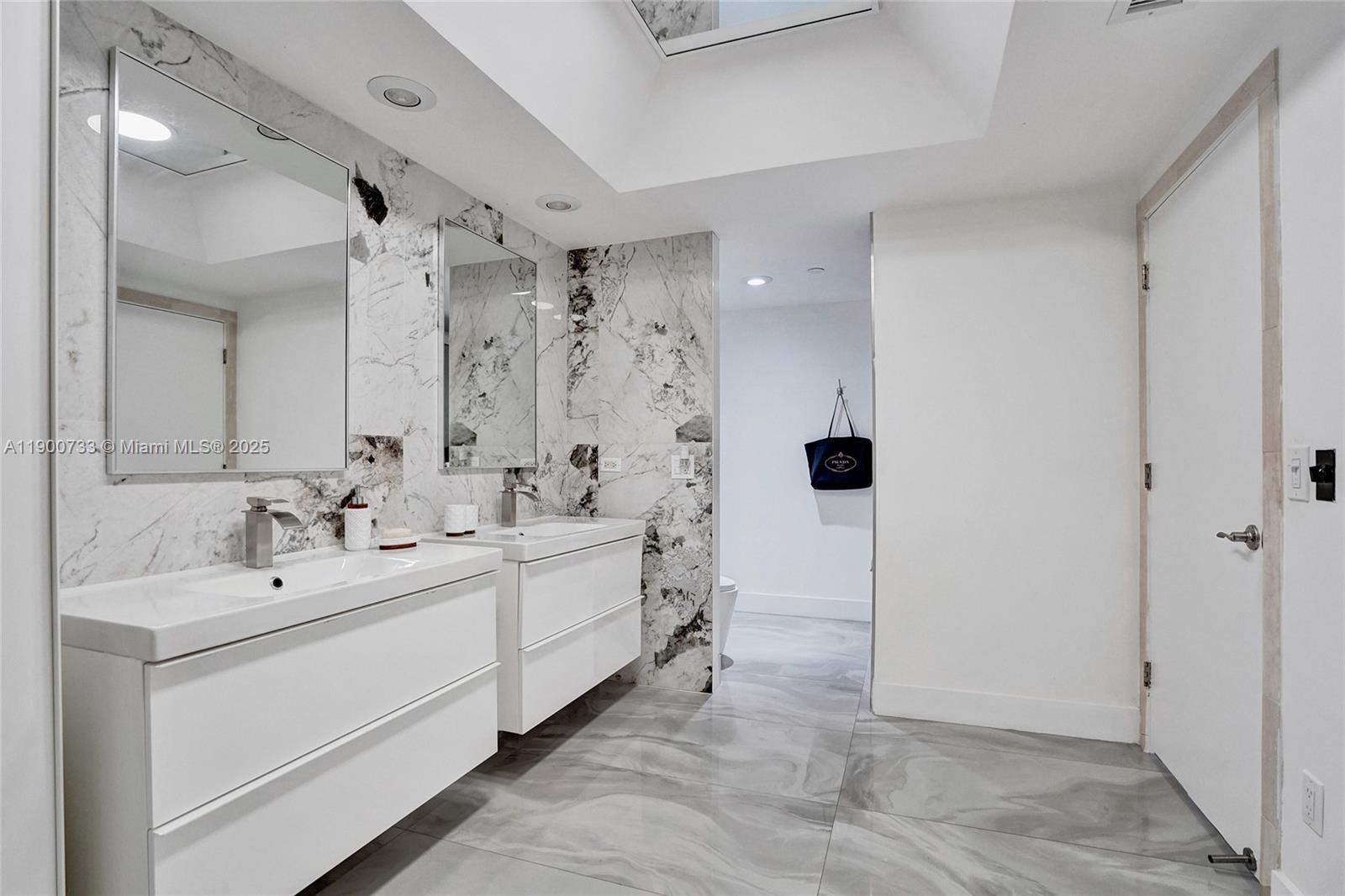 3000 Island Boulevard, Unit 1106 Aventura, FL 33160 - Photo 34 of 71 a bathroom with a double vanity sink mirror and shower