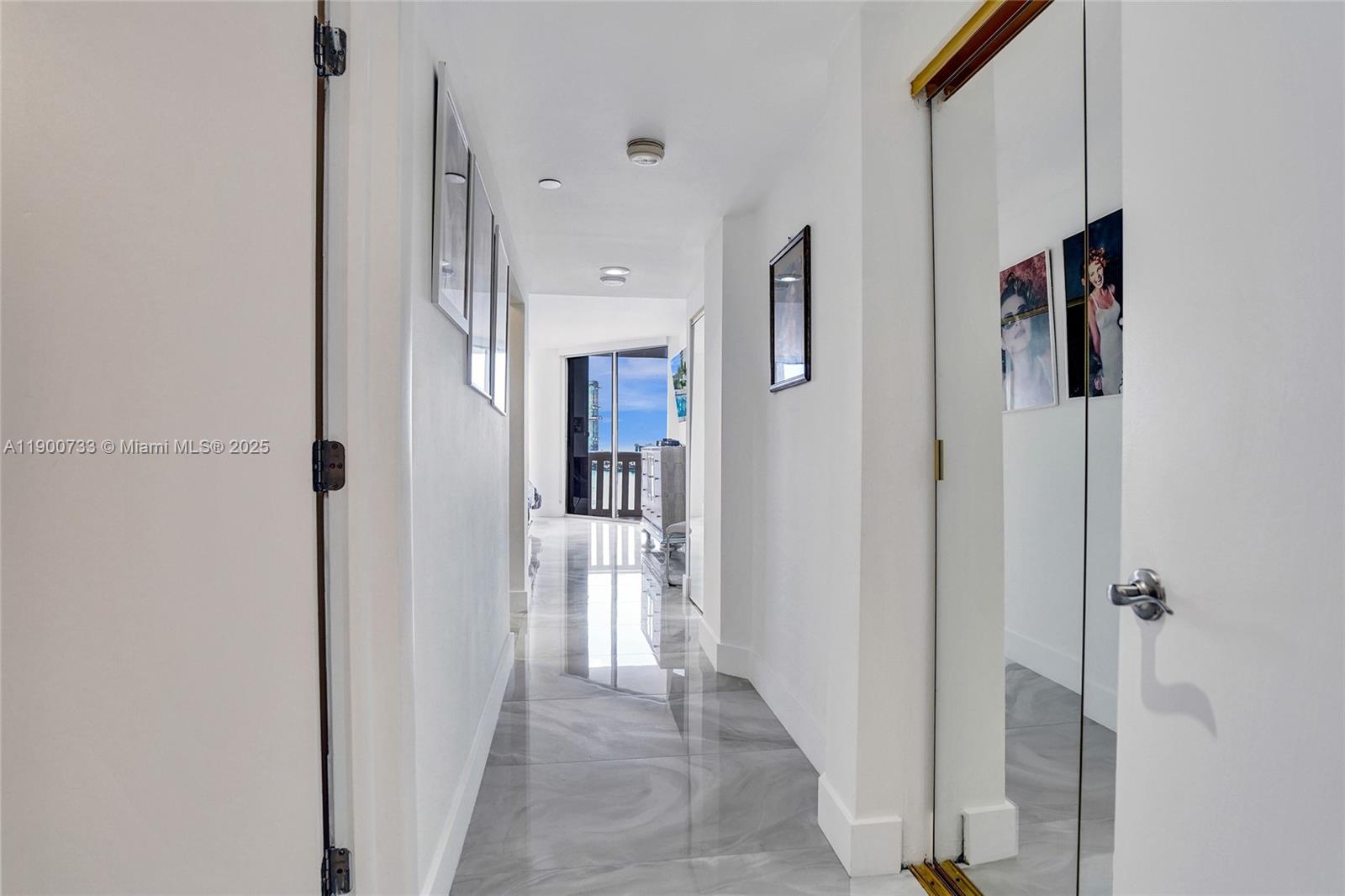 3000 Island Boulevard, Unit 1106 Aventura, FL 33160 - Photo 37 of 71 a view of a hallway with a cabinet and a refrigerator
