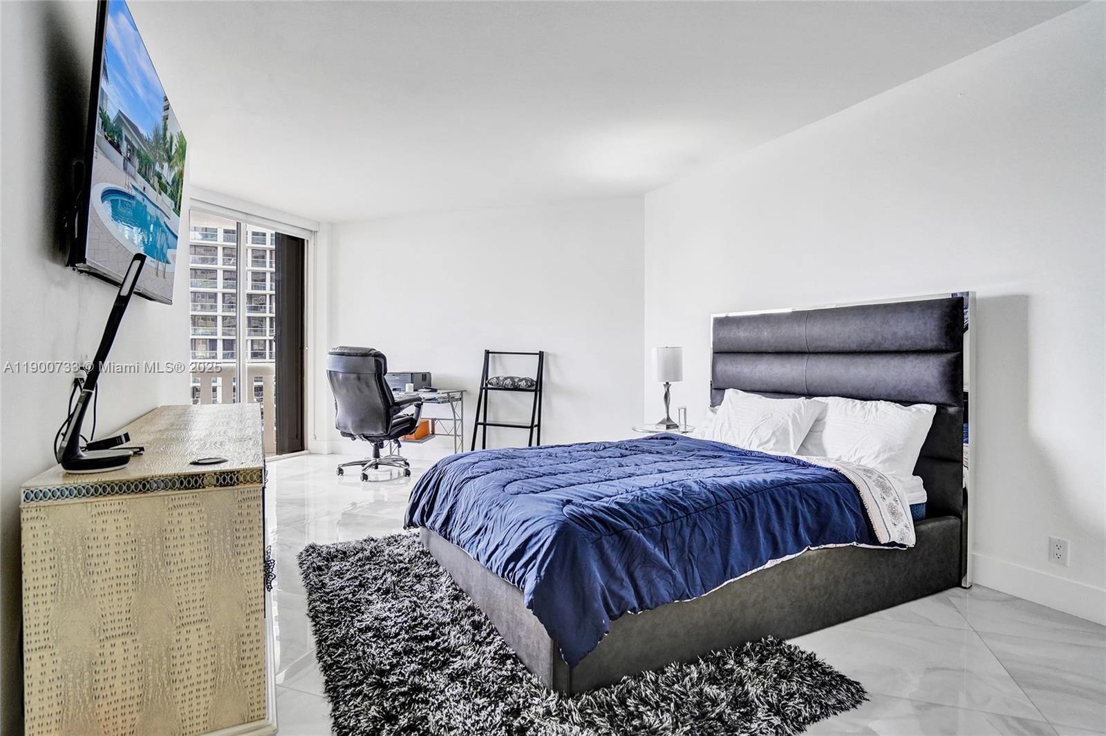 3000 Island Boulevard, Unit 1106 Aventura, FL 33160 - Photo 40 of 71 a bedroom with a bed and a night stand