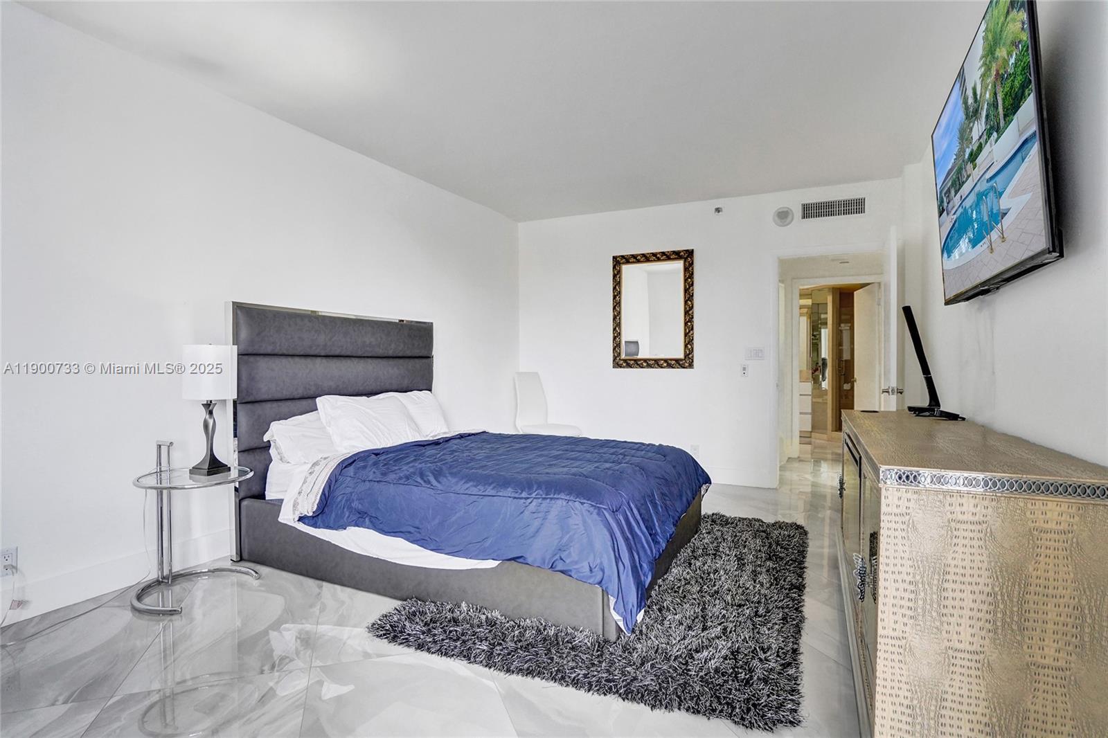 3000 Island Boulevard, Unit 1106 Aventura, FL 33160 - Photo 42 of 71 a bedroom with a bed and a painting on the wall