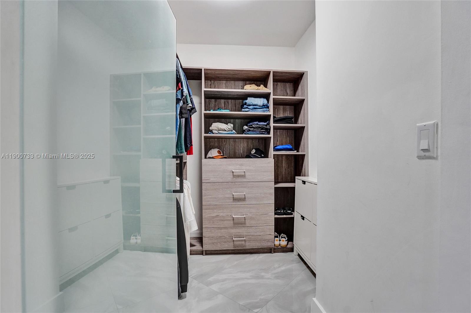 3000 Island Boulevard, Unit 1106 Aventura, FL 33160 - Photo 43 of 71 a view of walk in closet with empty racks