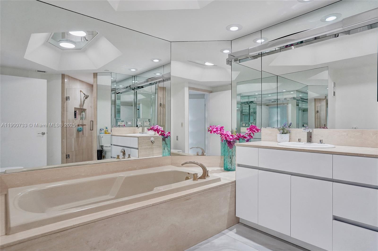 3000 Island Boulevard, Unit 1106 Aventura, FL 33160 - Photo 45 of 71 a bathroom with a tub a sink shower and a mirror