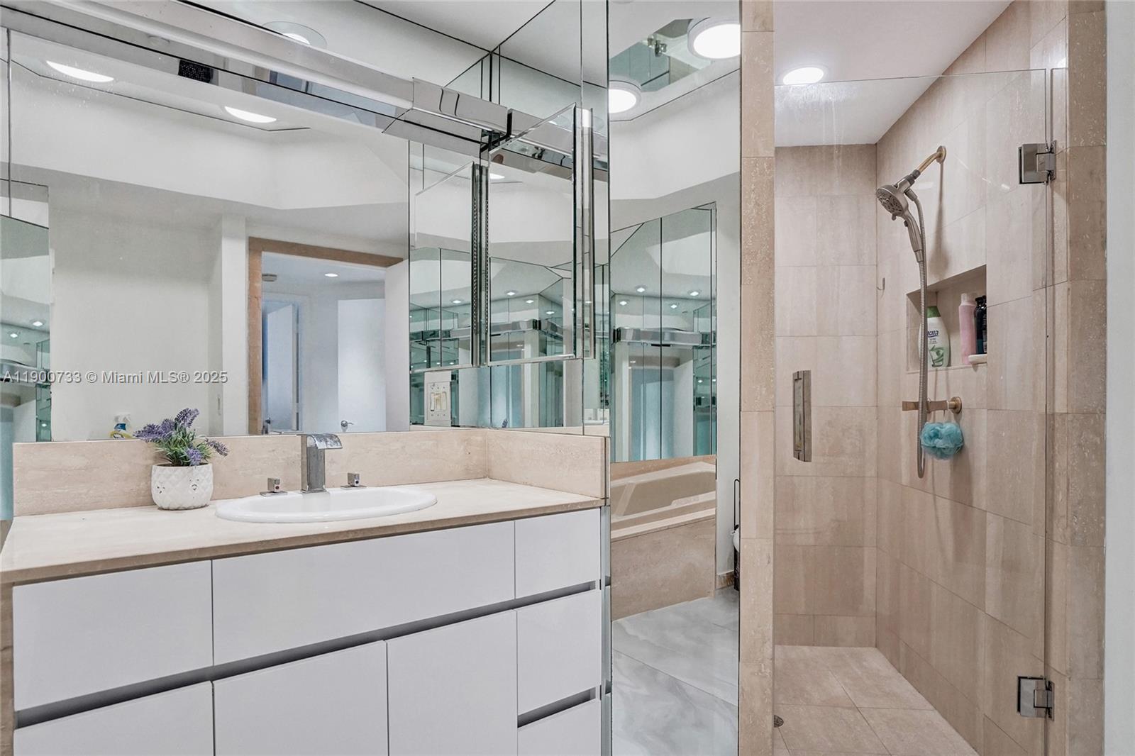 3000 Island Boulevard, Unit 1106 Aventura, FL 33160 - Photo 46 of 71 a bathroom with a double vanity sink mirror and shower