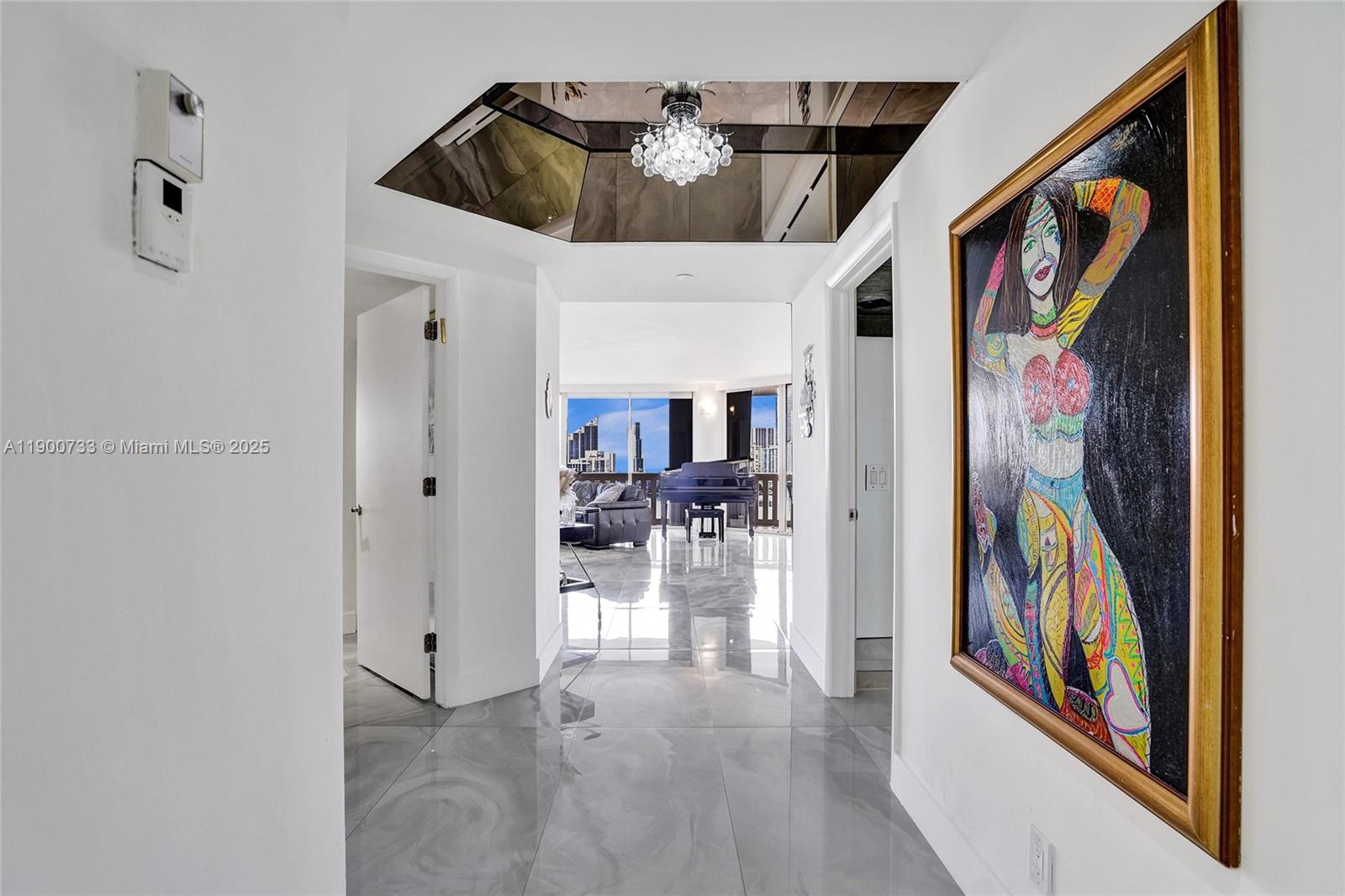 3000 Island Boulevard, Unit 1106 Aventura, FL 33160 - Photo 6 of 71 a view of a hallway with a dining table with wooden floor