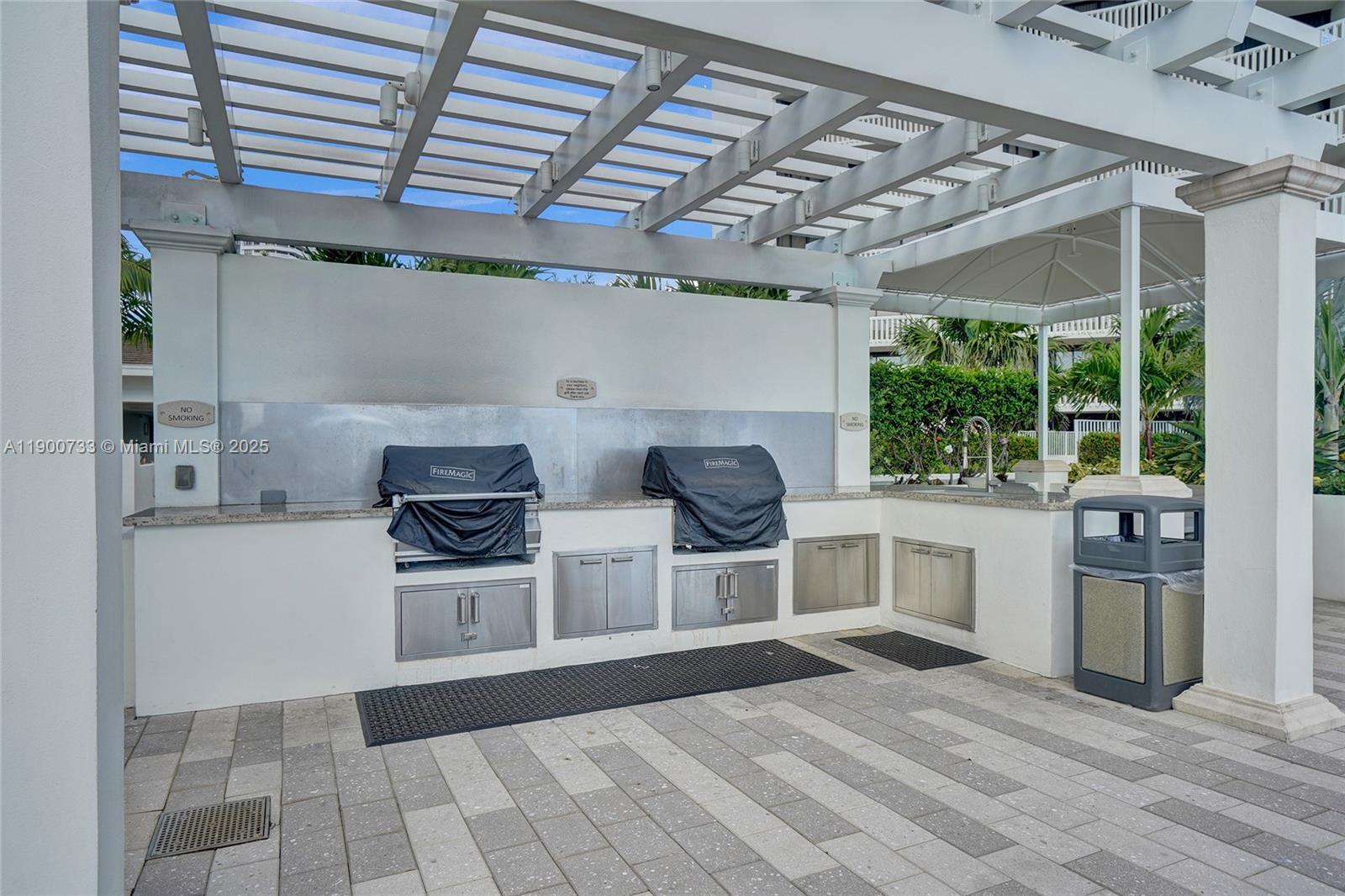 3000 Island Boulevard, Unit 1106 Aventura, FL 33160 - Photo 64 of 71 a view of a kitchen with stainless steel appliances granite countertop a stove and a refrigerator