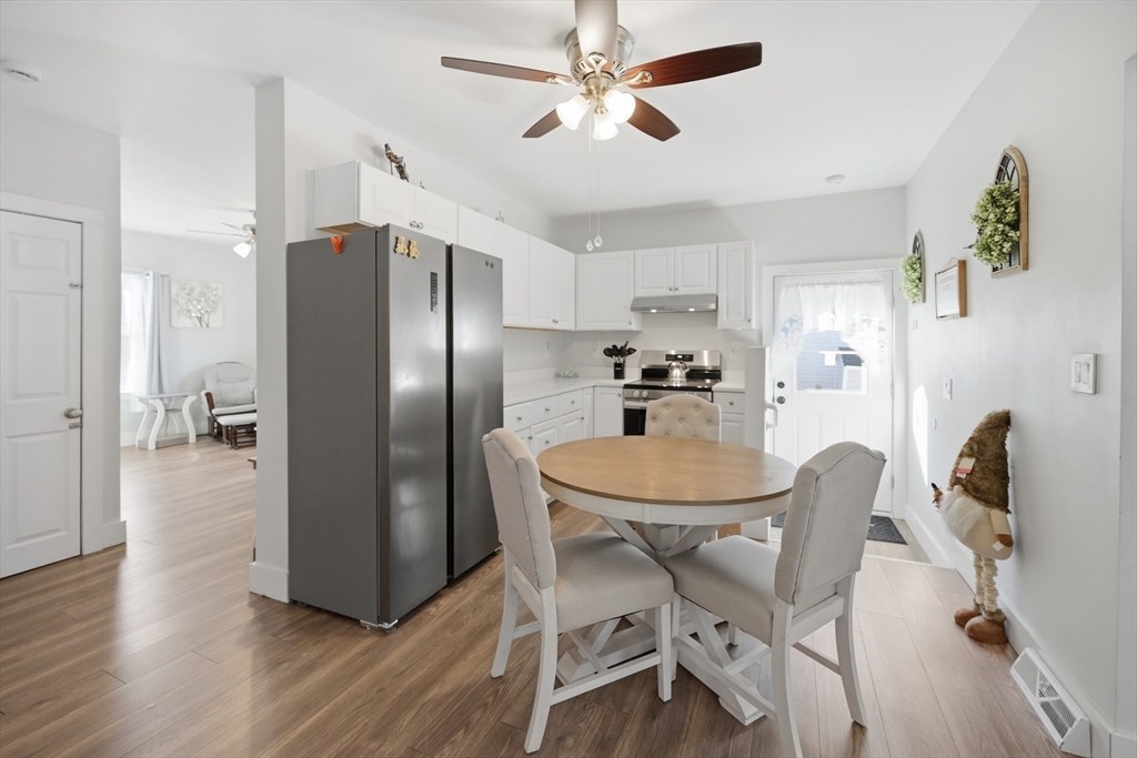 70 Wyman Street Lynn, MA 01905 - Photo 11 of 41 a kitchen with stainless steel appliances a refrigerator a table and chairs