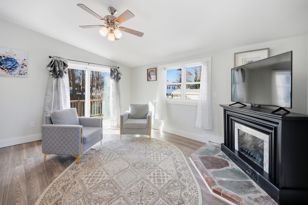 70 Wyman Street Lynn, MA 01905 - Photo 13 of 41 a living room with furniture and a fireplace