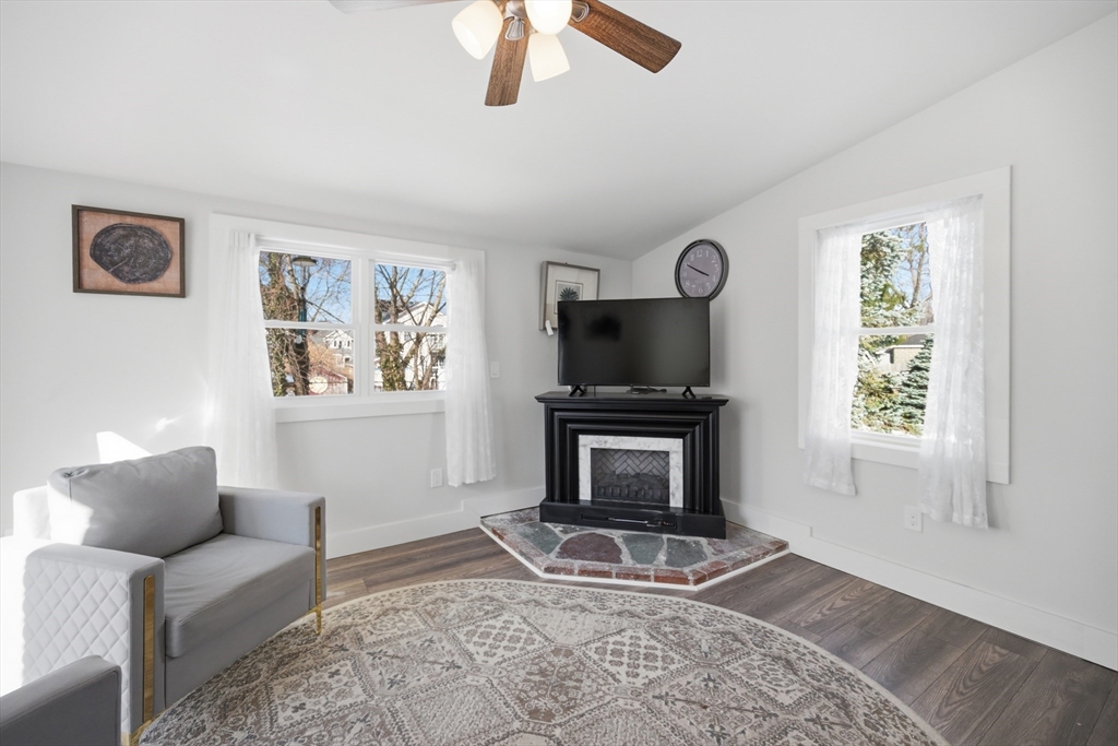70 Wyman Street Lynn, MA 01905 - Photo 14 of 41 a living room with furniture a flat screen tv and a fireplace