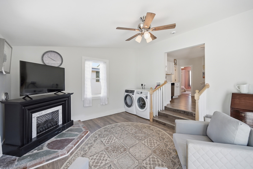 70 Wyman Street Lynn, MA 01905 - Photo 15 of 41 a living room with furniture a flat screen tv and a fireplace