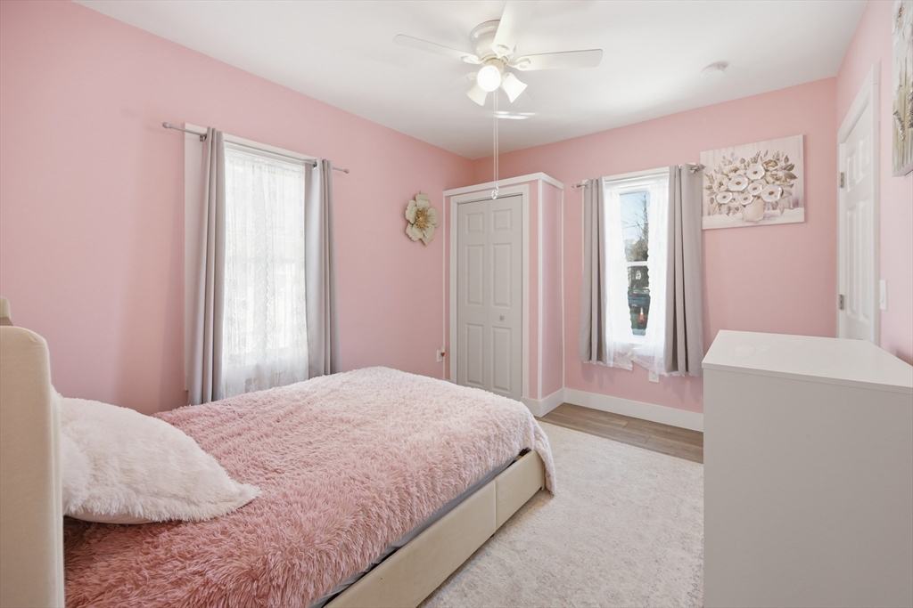 70 Wyman Street Lynn, MA 01905 - Photo 20 of 41 a bedroom with a large bed and a chandelier